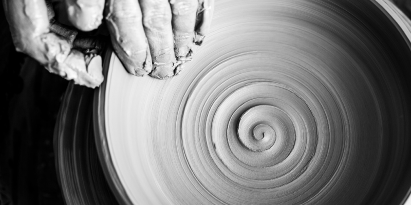 Skilled hands doing pottery spiral